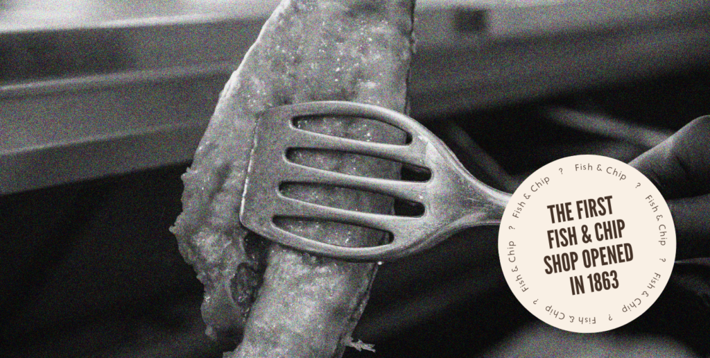Tongs holding battered fish in black and white effect, featuring a badge that says: The first fish and chip shop opened in 1863